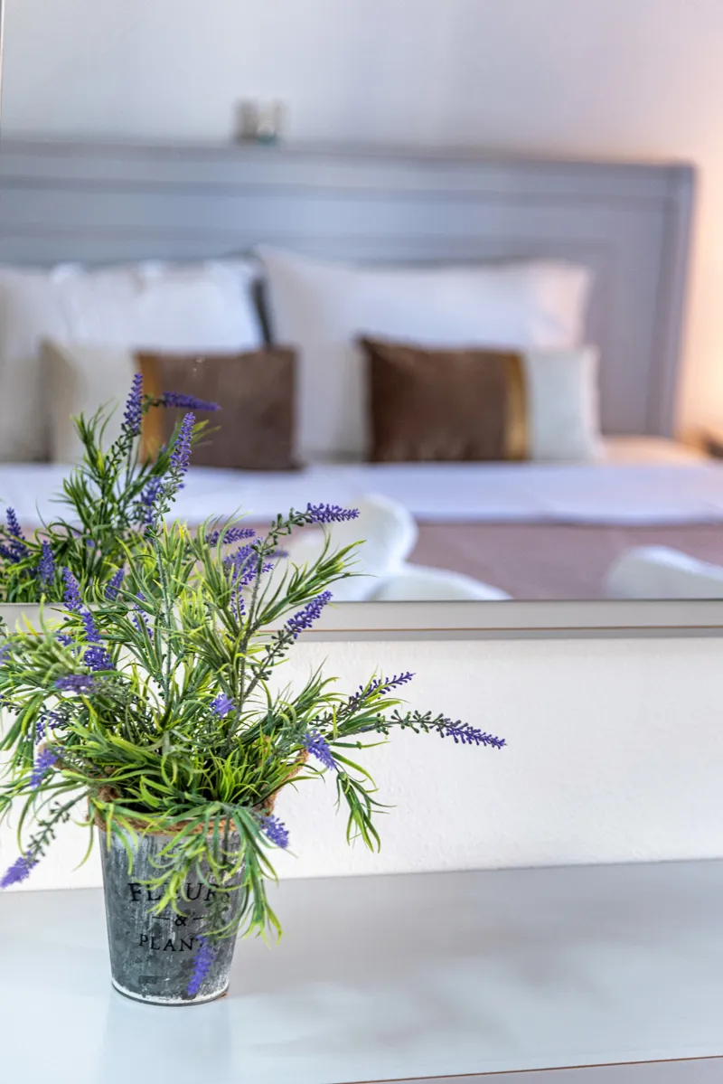 A made bed with fresh lavender