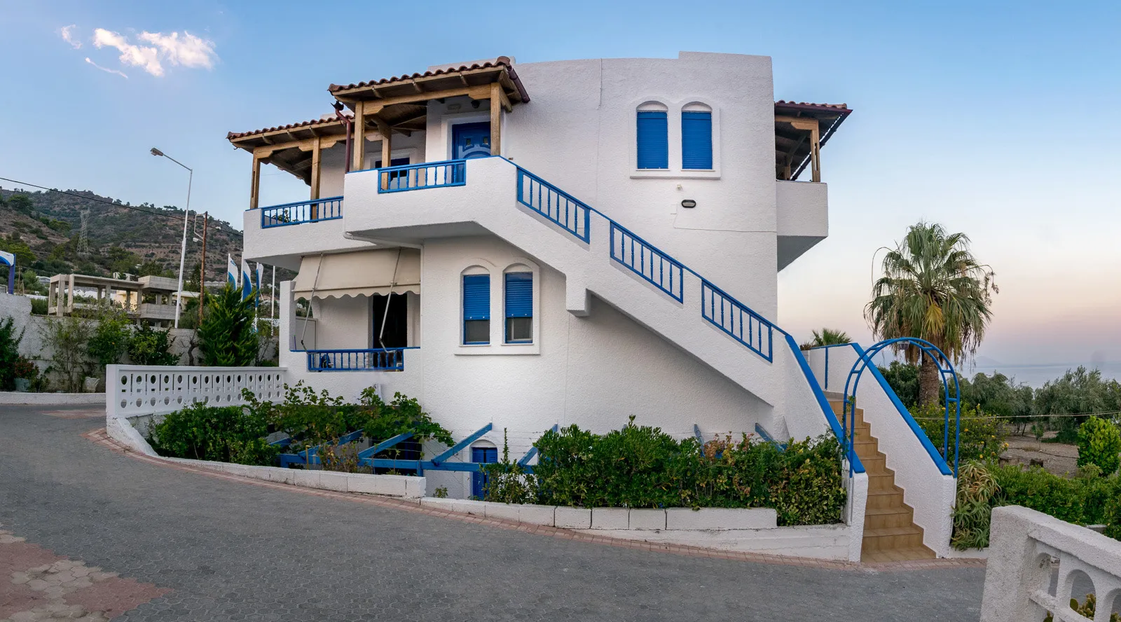 The whitewashed exterior with blue shutters