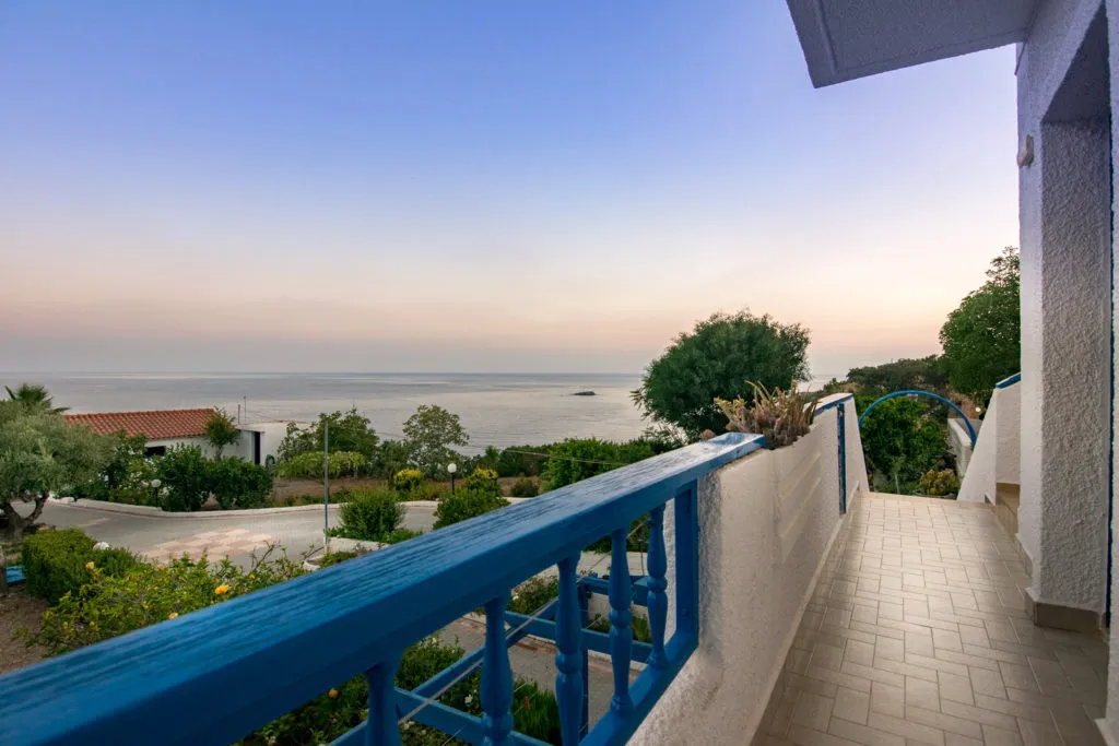 A private terrace at dusk looking over the sea